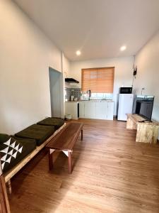 a living room with a couch and a table at Bann Aui Homestay in Fang +7 photos