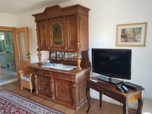 ein großer Holzschrank mit einem TV auf dem Tisch in der Unterkunft "Am Prerow Strom" in Prerow + 18 Fotos