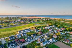 an aerial view of a residential neighborhood next to the ocean at Dom Marina Mosty, Sauna Hot Tub Holiday Home near Rewa Gdańsk in Mosty +38 photos