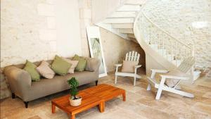 a living room with a couch and a table at Le Cottage Brantôme in Bourrou