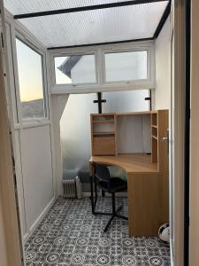 an office with a desk and a window at Luxury Spacious Flat close to Central London in London +2 photos