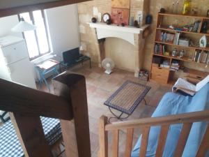 an aerial view of a living room with a fireplace at un gîte des ânes in Bergerac