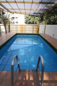 a large swimming pool on top of a building at HemHarsh Holiday Home with pool in Karjat