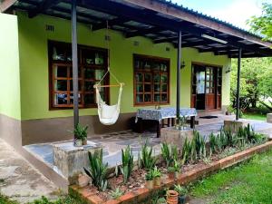 a house with a hammock outside of it at Mikooka Estate in Chongwe