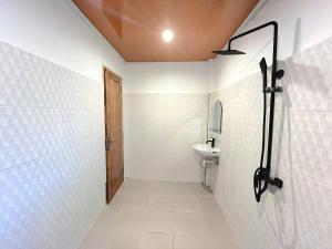 a bathroom with a toilet and a sink at NeNa Eat & Sleep Kuta in Kuta Lombok