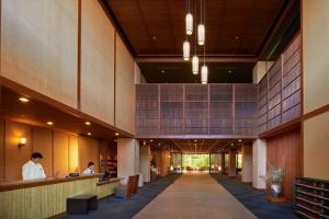 a lobby of a building with people sitting at a counter at Koran no Yu Kinkouro in Ibusuki