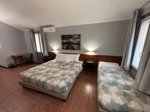 Postel nebo postele na pokoji v ubytování Villa Nasti Hotel Ristorante