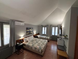 Postel nebo postele na pokoji v ubytování Villa Nasti Hotel Ristorante