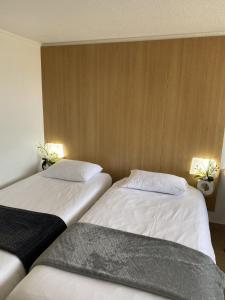 Postel nebo postele na pokoji v ubytování Kyriad ECO - Belfort Bessoncourt