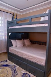 a bedroom with two bunk beds in a room at Barnabas Nakuru Comfy Homestays in Nakuru