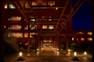 a building with candles in front of it at night at Koran no Yu Kinkouro in Ibusuki