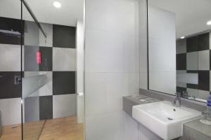 a bathroom with a sink and a mirror at favehotel Ahmad Yani Banjarmasin in Banjarmasin +17 photos