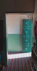a bedroom with a blue dresser with fish on it at Tabrany in Qaryat Abū Bakr aş Şiddīq