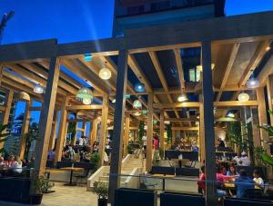 a restaurant with people sitting at tables in a building at Yvo 18 by Signature in Mamaia Sat/Năvodari