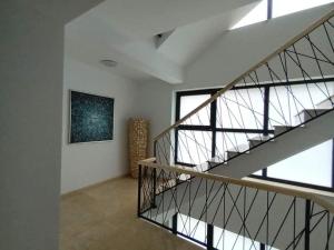 a staircase in a house with a painting on the wall at Yvo 18 by Signature in Mamaia Sat/Năvodari +52 photos