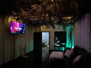 a living room with a tv on the wall at Star house old town lanta in Ko Lanta