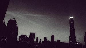 a silhouette of a city skyline at night at Residency Hotel Bangkok in Bangkok