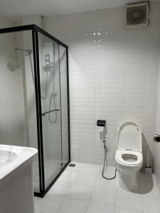 a bathroom with a shower and a toilet and a sink at Star house old town lanta in Ko Lanta +20 photos