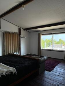 a bedroom with a large bed and a large window at Star house old town lanta in Ko Lanta