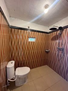 a bathroom with a toilet and a shower at Afu Resort Raja Ampat in Saonek