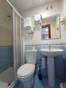 a bathroom with a toilet and a sink and a shower at Puente Azud in Avilés +19 photos