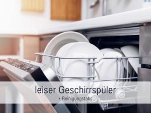 a dishwasher with plates and dishes in it at Casa Isabella Lauf, wunderschöne Aussicht - ruhig gelegen - top für Familien und Geschäftsreisen, super ausgestattet in Lauf +11 photos