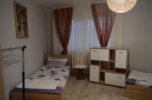 a bedroom with two beds and a dresser in it at Стаи за гости VIVIA in Veliko Tŭrnovo