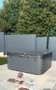 a bench sitting on a patio next to a fence at Apartman Malus in Gornji Vukojevac