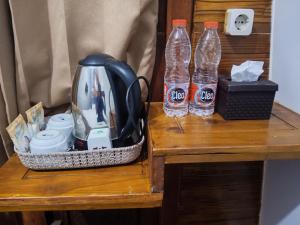 two bottles of water sitting on a table at Indah Damai Cottages in Sidomukti
