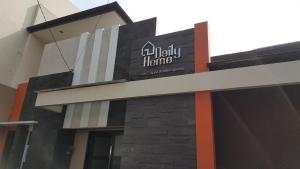 a building with a sign for aahilly home at Daily Home in Bandung
