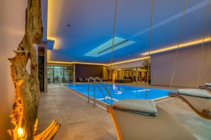 a swimming pool with a blue ceiling at Ringhotel Forellenhof in Walsrode