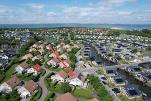 an aerial view of a suburb with a red arrow at Ferienhaus Fridolin Fort Soleil 27, Breskens Zeeland in Breskens