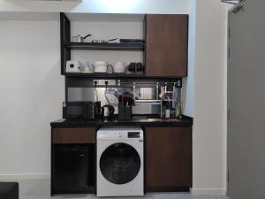 a kitchen with a washer and a dishwasher at Bay Suite - Minuli in Kota Kinabalu
