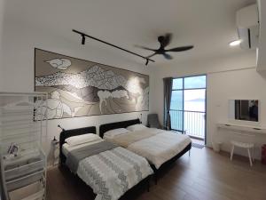 a bedroom with a bed and a ceiling fan at Bay Suite - Minuli in Kota Kinabalu