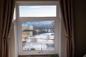 a window with a view of a snow covered field at Southview Barkisland in Halifax