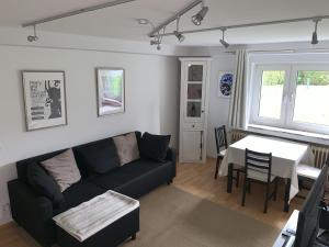 a living room with a couch and a table at Apartment Isenbügel / Essen-Kettwig in Heiligenhaus