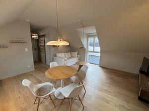 a living room with a table and chairs and a couch at L'appartement in Gruson
