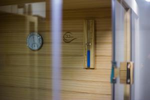 a clock on the side of a wooden door at Kuća za odmor Fjaka in Sotin +38 photos