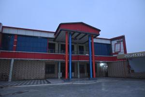 an empty building with blue and red columns at Rajpal Hotels in Orai