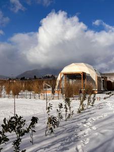 a yurt in a field with snow on the ground at Glamping Liptov in Liptovský Trnovec