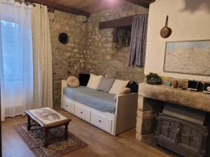 a living room with a couch and a fireplace at Le Logis de la Cour de Bretagne au Port de Dinan Lanvallay in Lanvallay