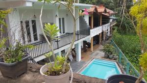 an external view of a house with a swimming pool at southern grace hotel in Unawatuna