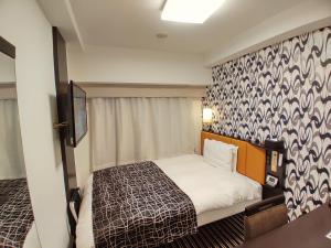 Postel nebo postele na pokoji v ubytování APA Hotel Nagatacho Hanzomon Ekimae