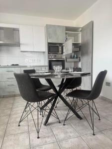 a kitchen with a table and chairs in a room at La Vie Royale in Nicosia +8 photos