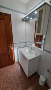 a bathroom with a white sink and a mirror at LaCasa DeLola in Almodóvar del Río