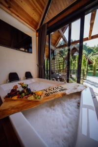 a bed in a room with a tray of fruit on it at Yazici Green Villas Tatil Koyu in Rize