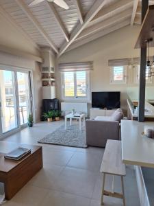 a living room with a couch and a table at Elia boutique apartment in Thiva