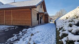 a house with snow on the side of it at Gite châlet nature haute vosges in Anould