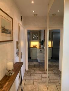 a kitchen with a tile floor and a hallway at Klagenfurt Living 85 in Klagenfurt +27 photos