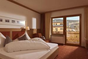 Posteľ alebo postele v izbe v ubytovaní Hotel Sonnalp